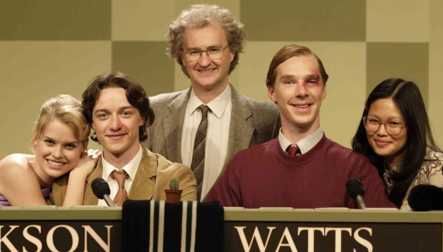 Alice Eve, James McAvoy, Mark Gatiss, Benedict Cumberbatch, and Elaine Tan sitting at a University Challenge desk