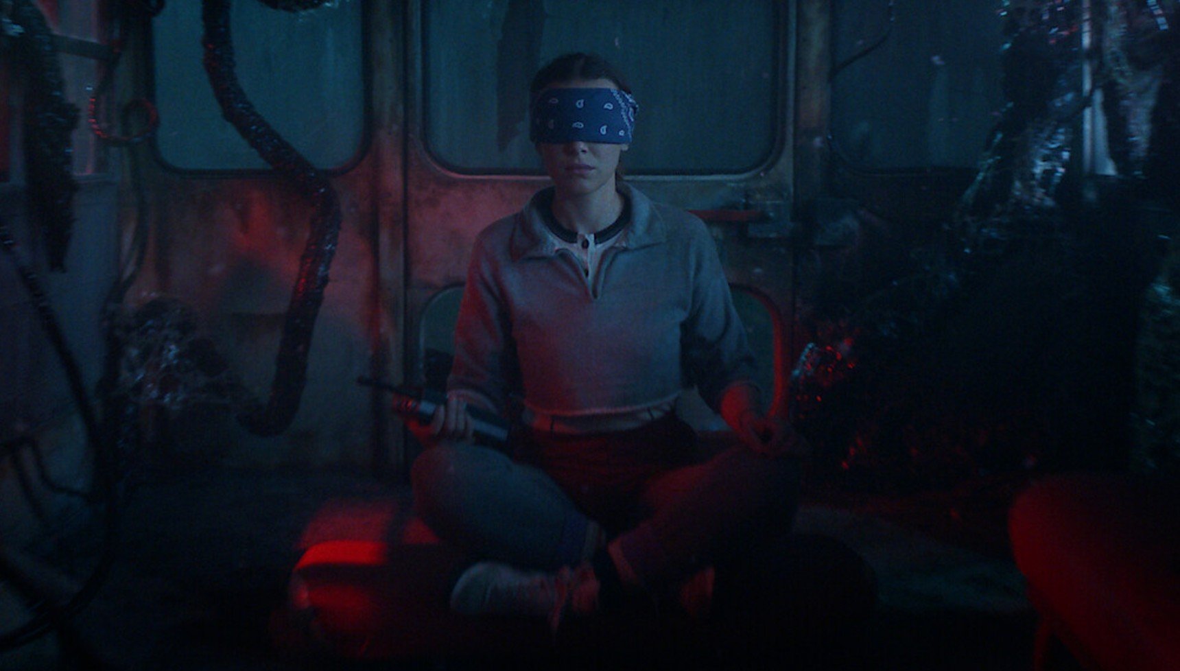 Eleven with a blindfold on in a dark bus in Stranger Things season 5