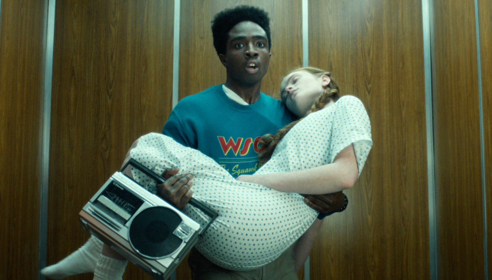 Lucas holding Max and a speaker in Stranger Things season 5