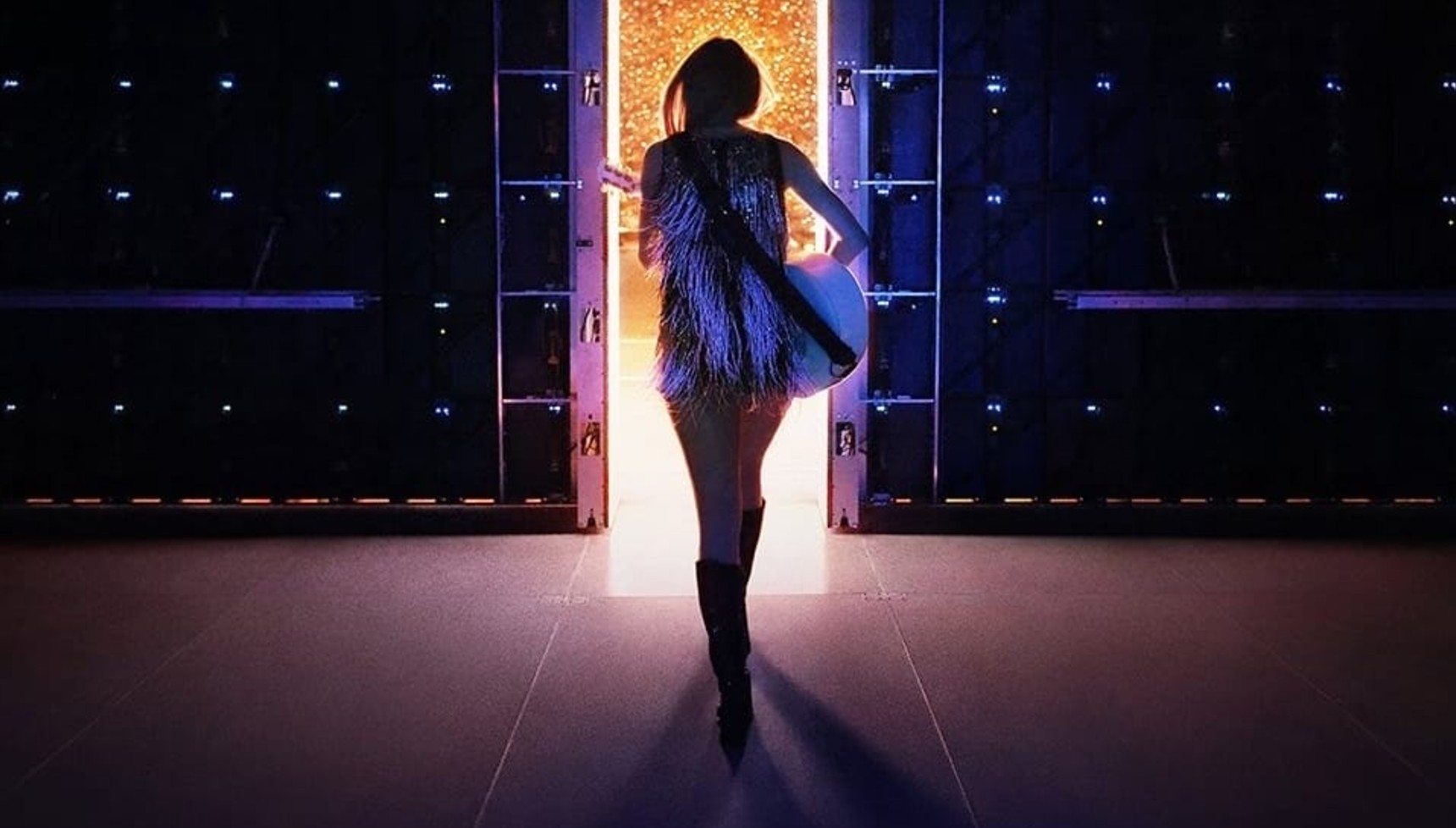 Taylor Swift holding a guitar and facing away in the poster for The End of an Era concert film