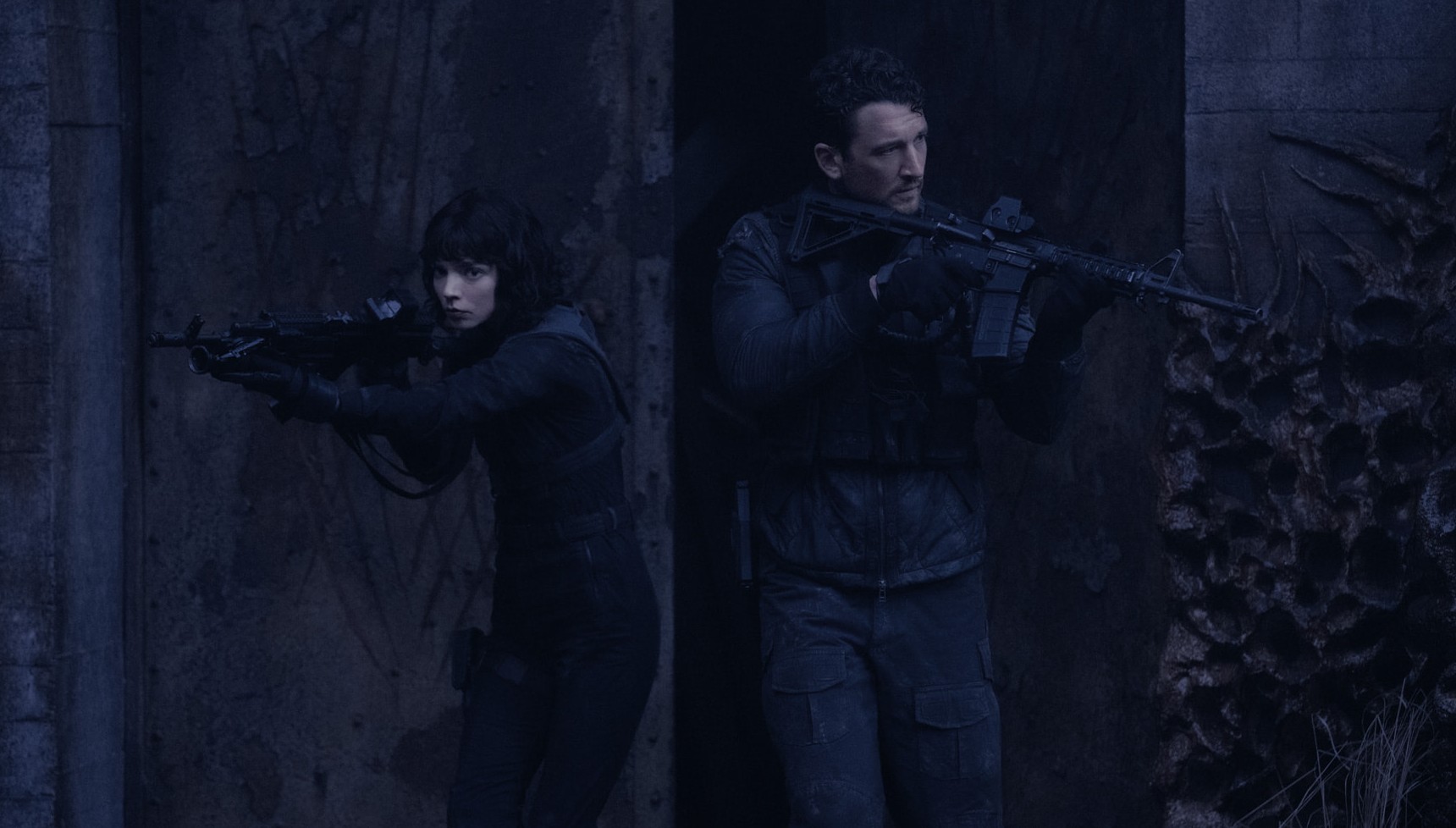 A male and a female sniper point their guns