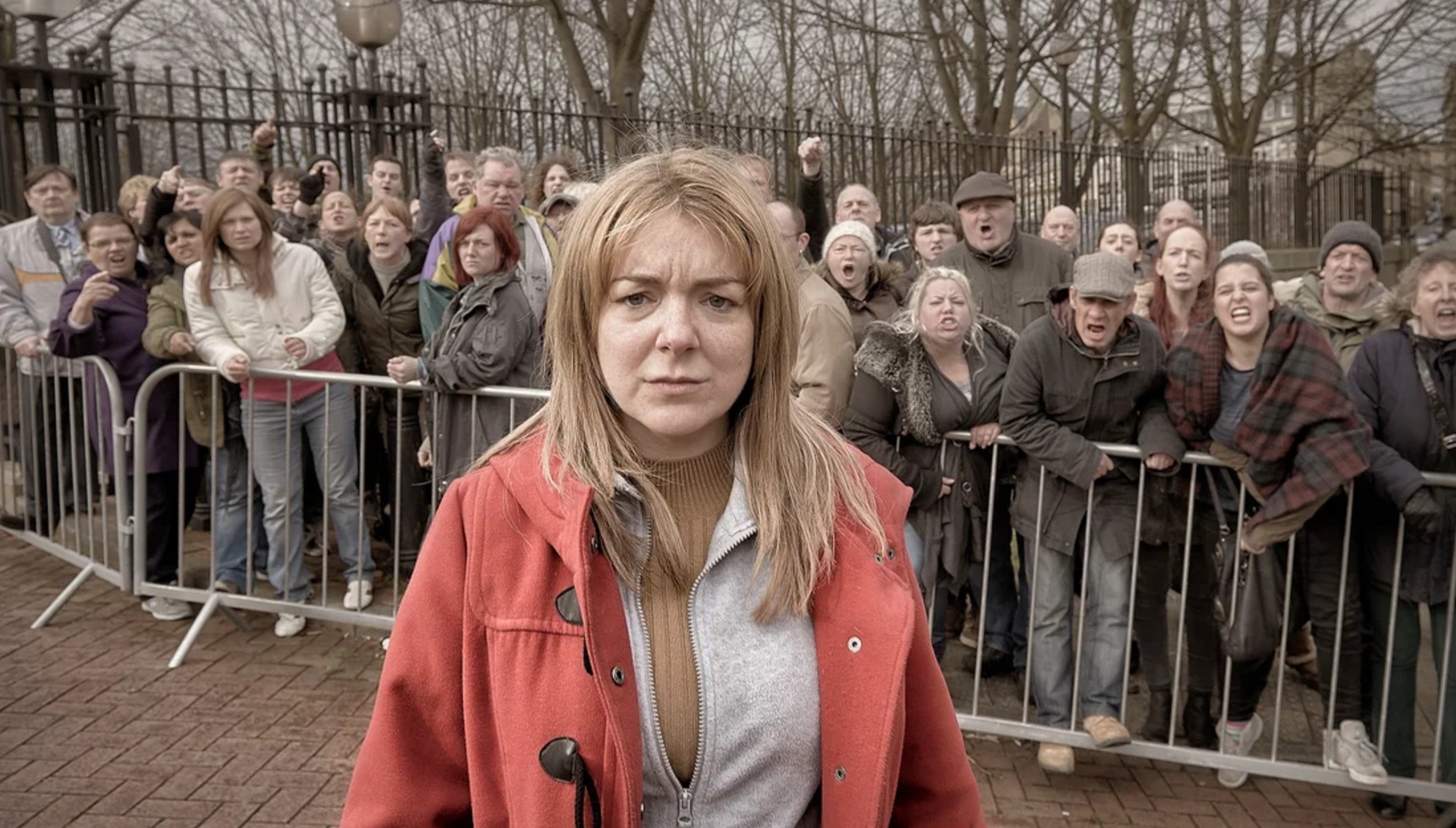 Sheridan Smith standing in front of an angry crowd in The Moorside
