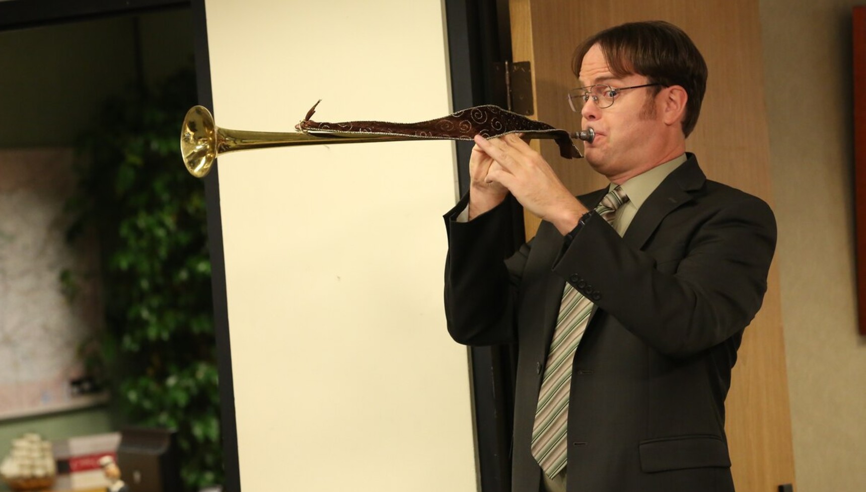 Riann Wilson playing an instrument in The Office US