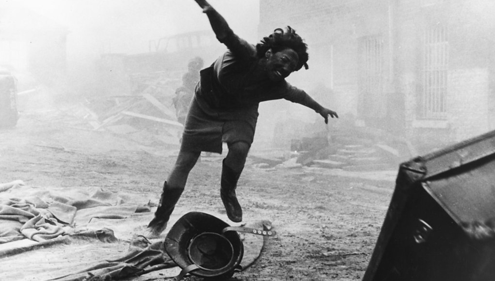A woman screaming as she runs through an ash-covered street in The War Game