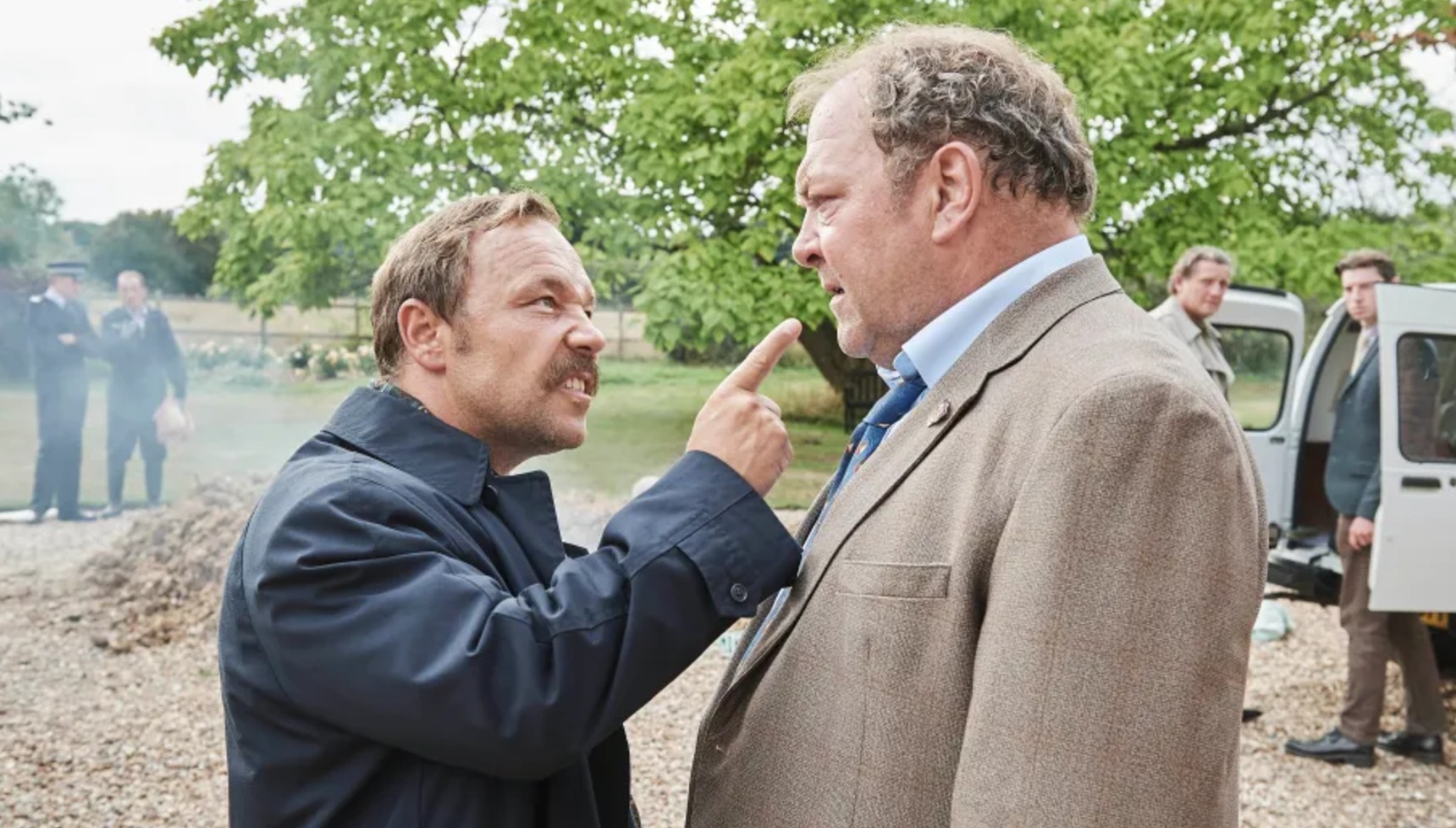 Stephen Graham shouting and pointing at Mark Addy in White House Farm