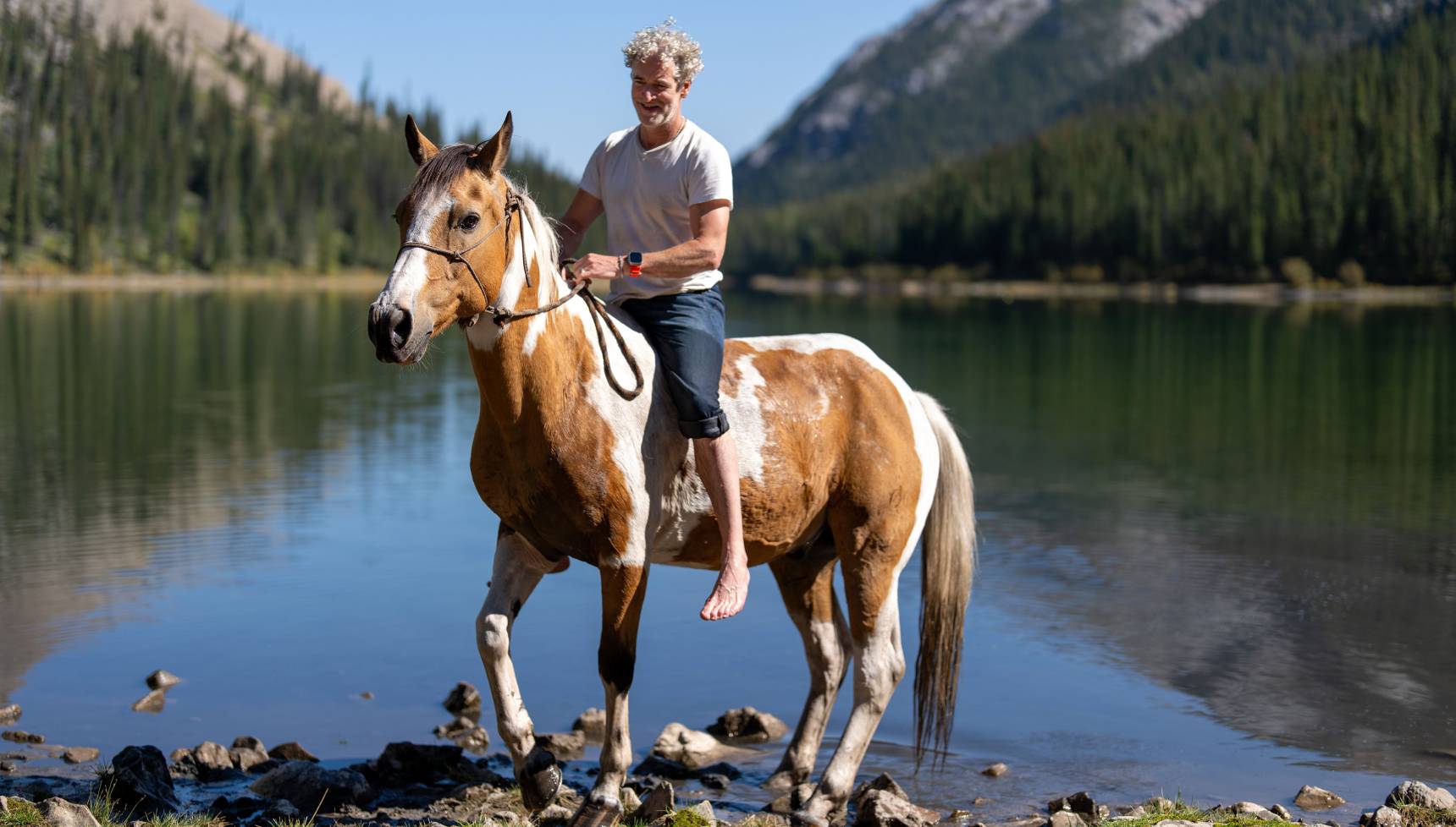 Gordon Buchanan on a horse for Wild Horses, the Rockies and Me