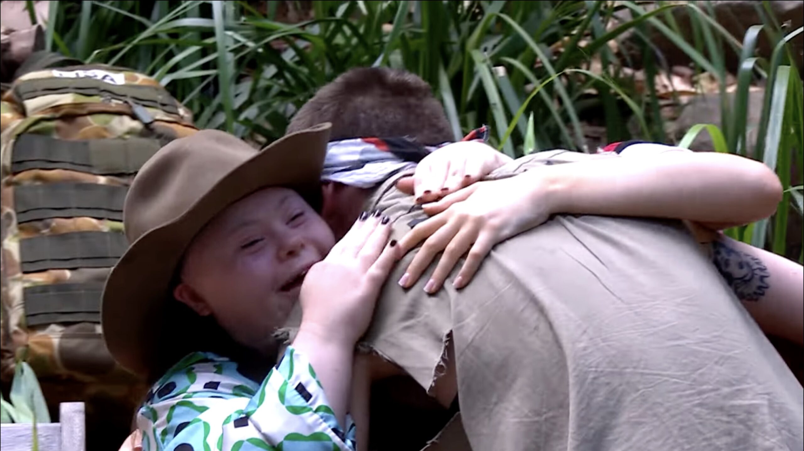 Aitch hugging his sisters