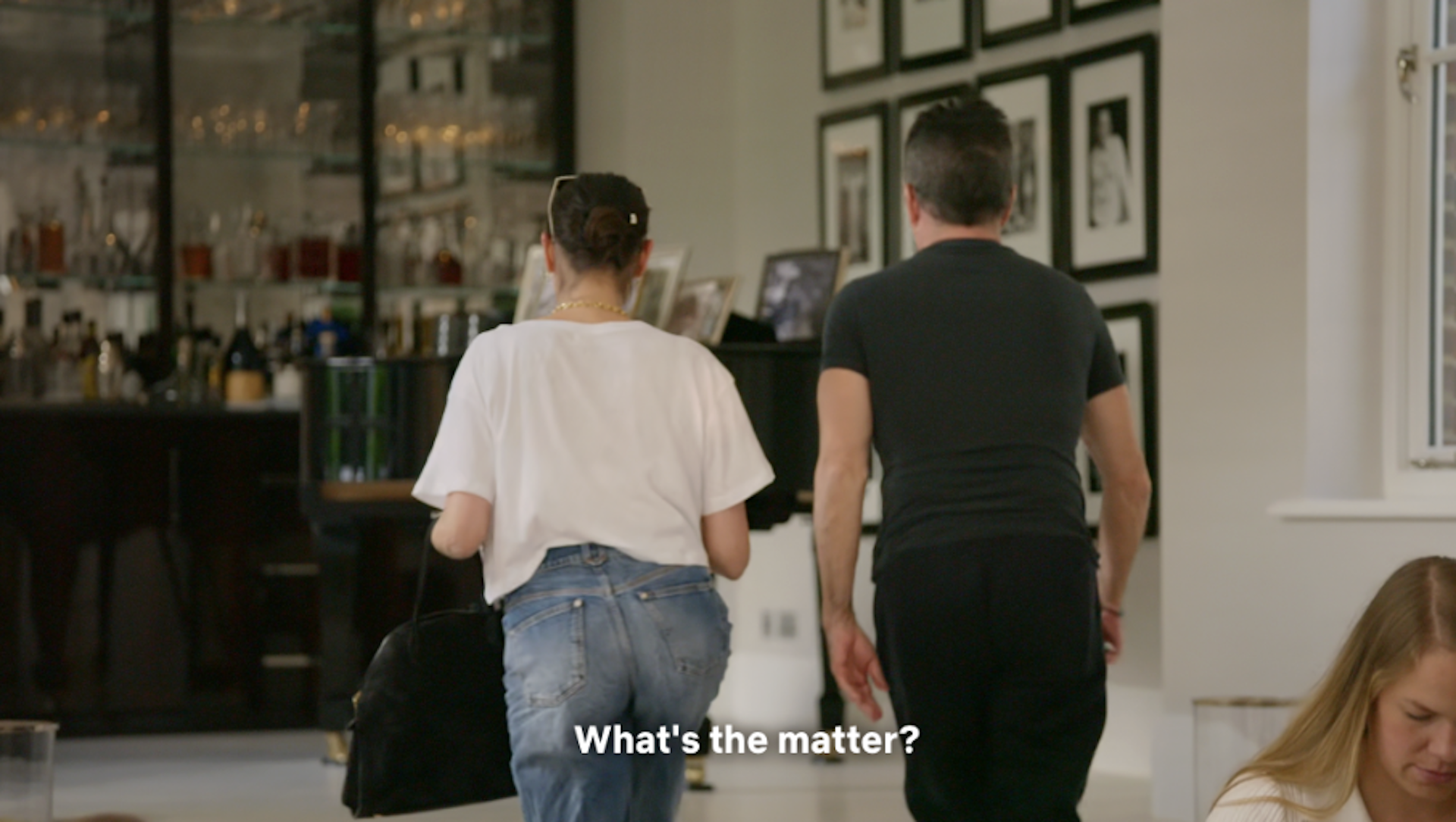 Simon and Lauren walking through the bar