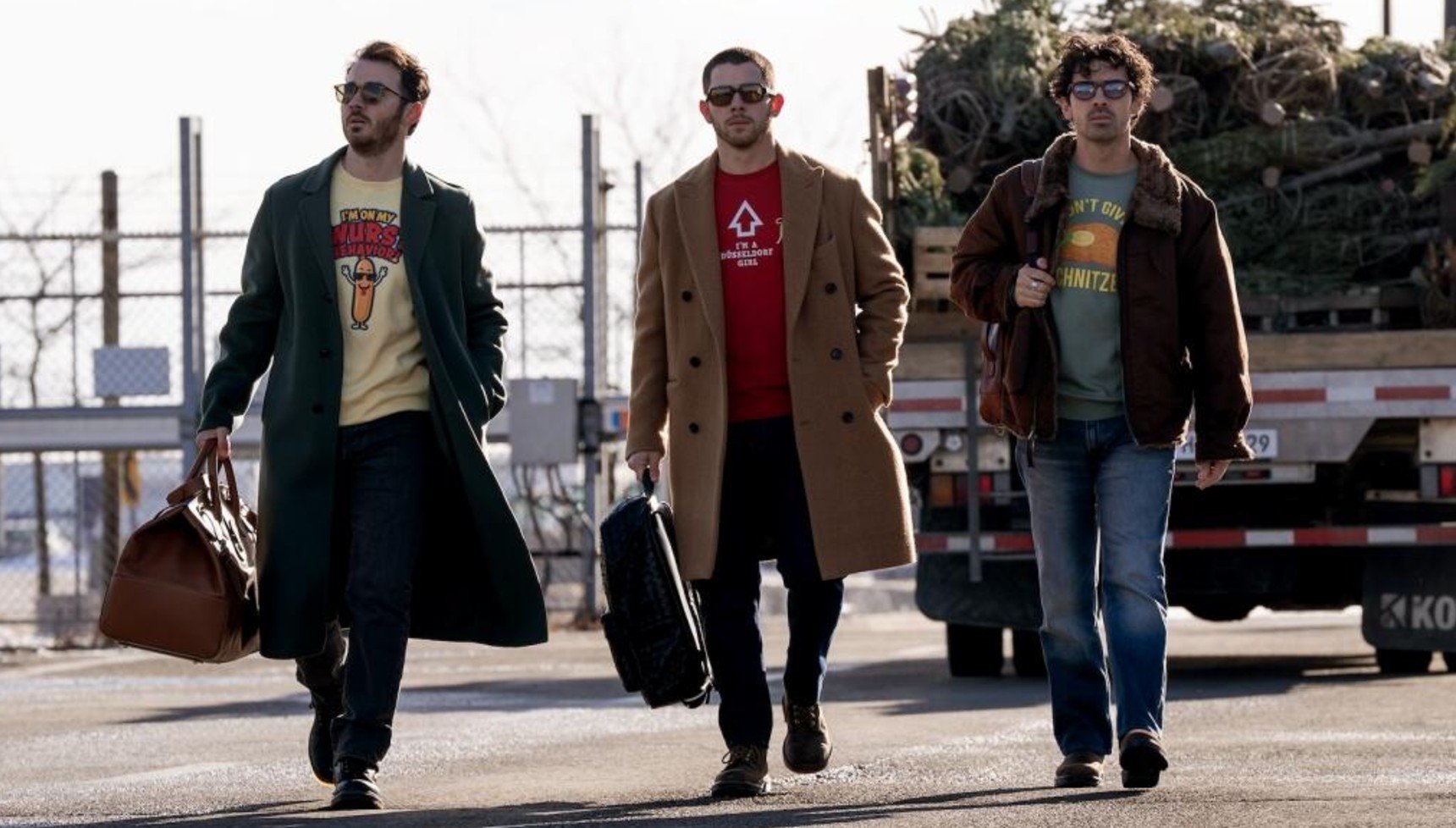 The Jonas Brothers walking in A Very Jonas Christmas