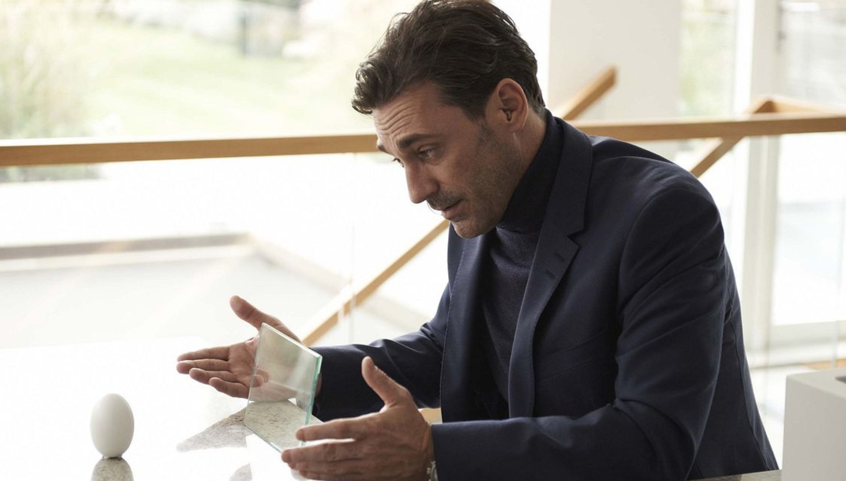 Jon Hamm looking at a small white egg in Black Mirror