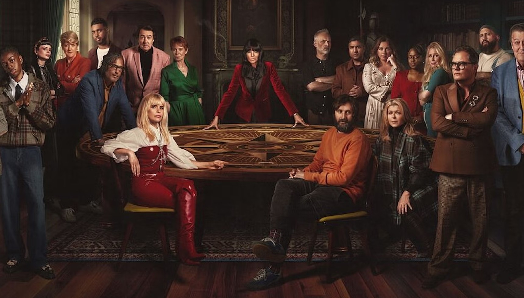 Claudia Winkleman at the Traitors roundtable with the celebrity cast from season 1