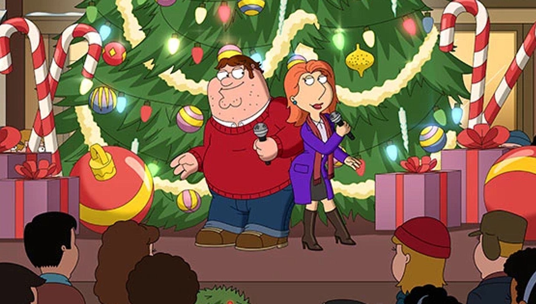 Peter and Lois singing in front of a Christmas tree in the Family Guy Christmas special 
