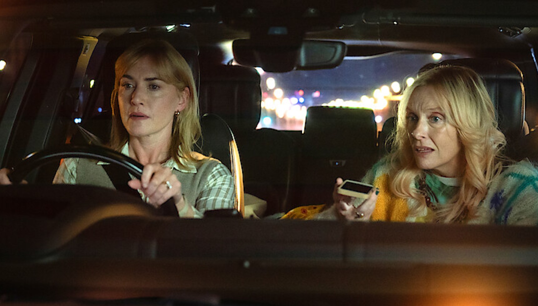 Kate Winslet driving a car next to Toni Colette in Goodbye June