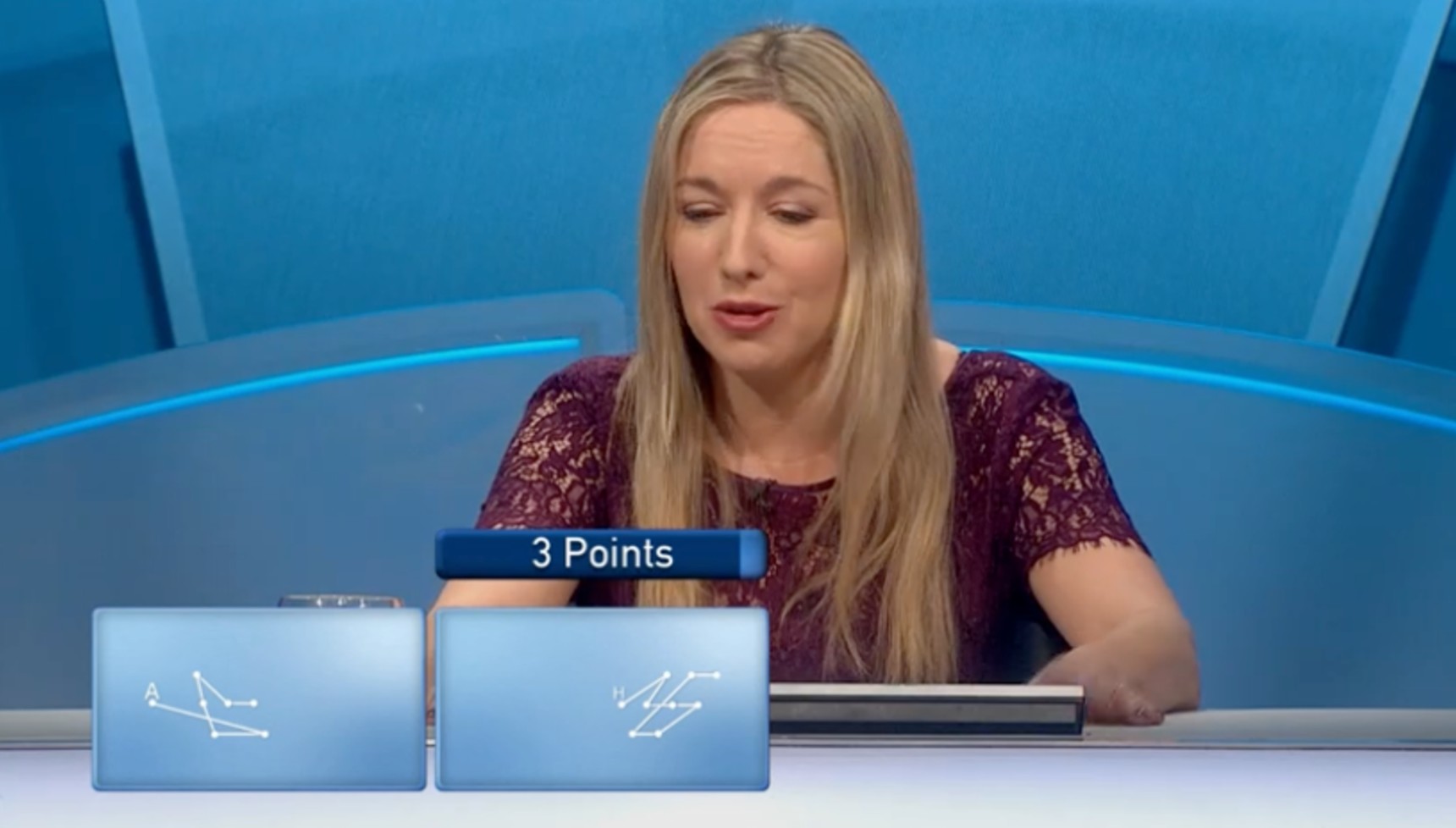 Victoria Coren Mitchell looking at half of the clues on an Only Connect question