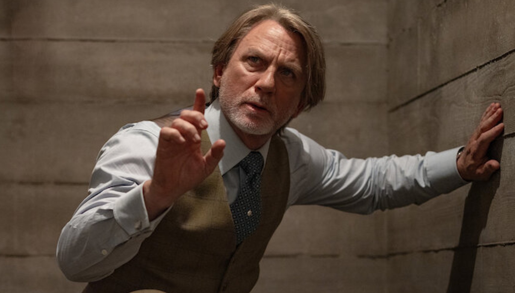 Daniel Craig holding his finger up in costume as Benoit Blanc in Wake Up Dead Man