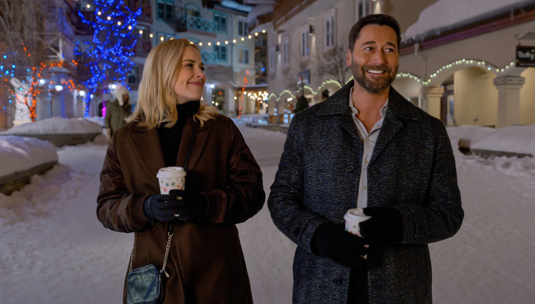 Alexandra Breckenridge walking next to Ryan Eggold in a snowy street in My Secret Santa