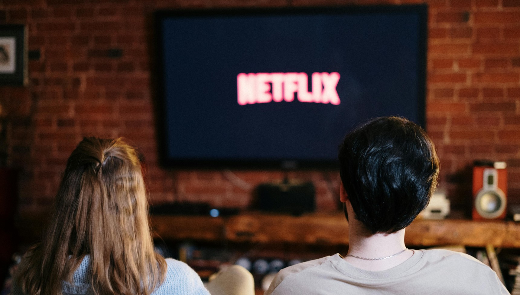 Two people watching Netflix on the TV