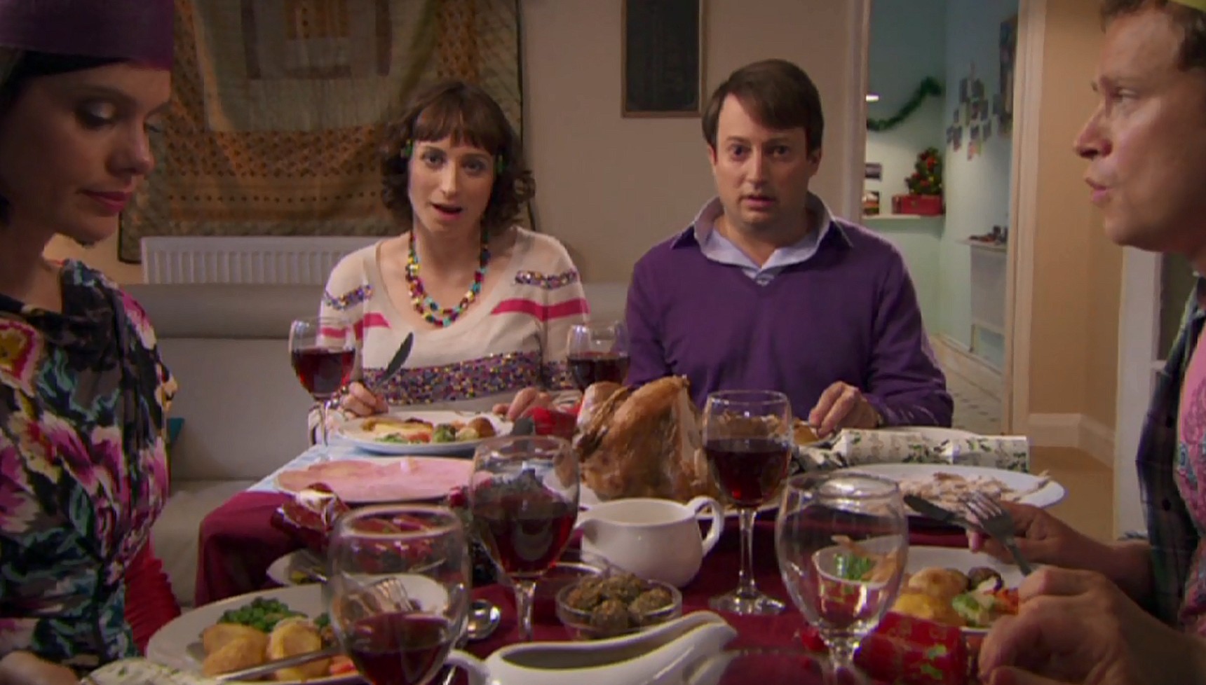 Mark and Dobby sitting in front of their Christmas lunch in Peep Show
