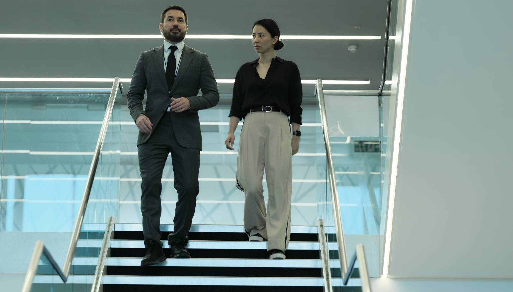 Clay and Hana walking down stairs in Red Eye series 2