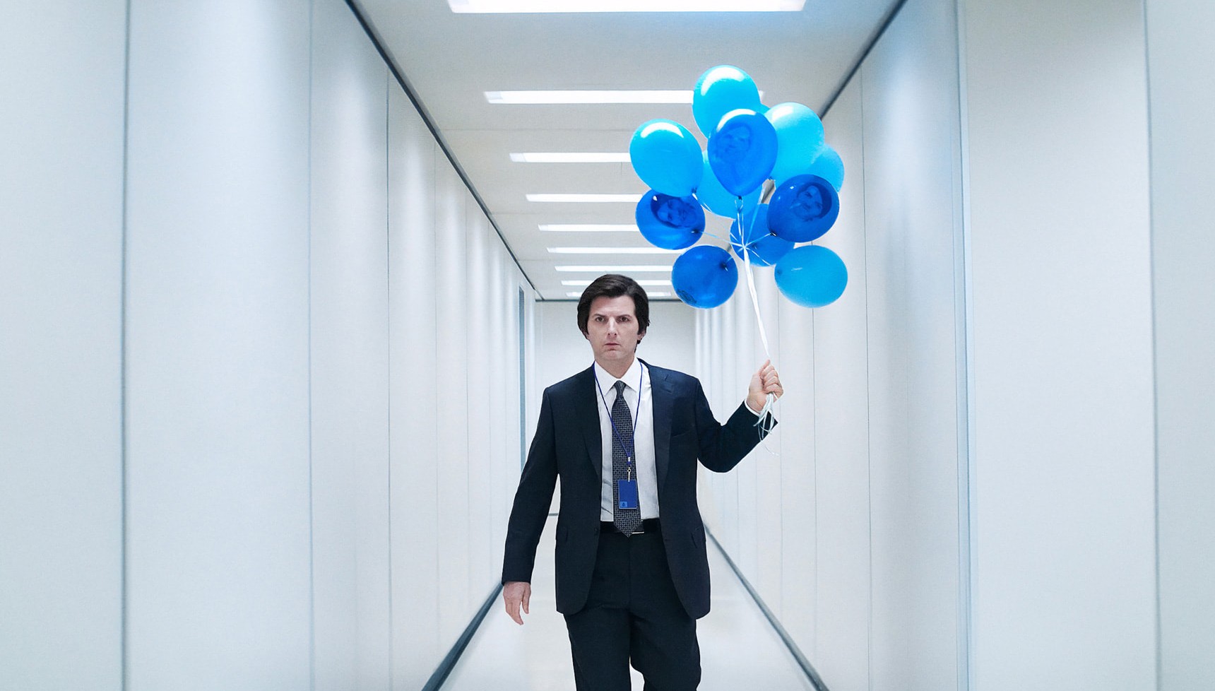 Adam Scott holding blue balloons in Severance season 2