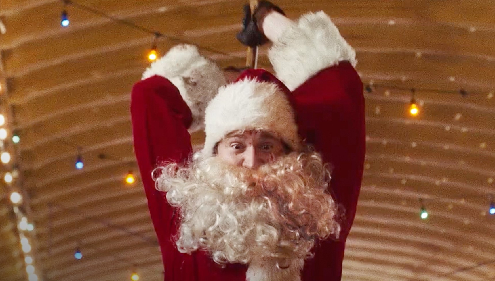 A man holding an axe while dressed as Santa in Silent Night Deadly Night