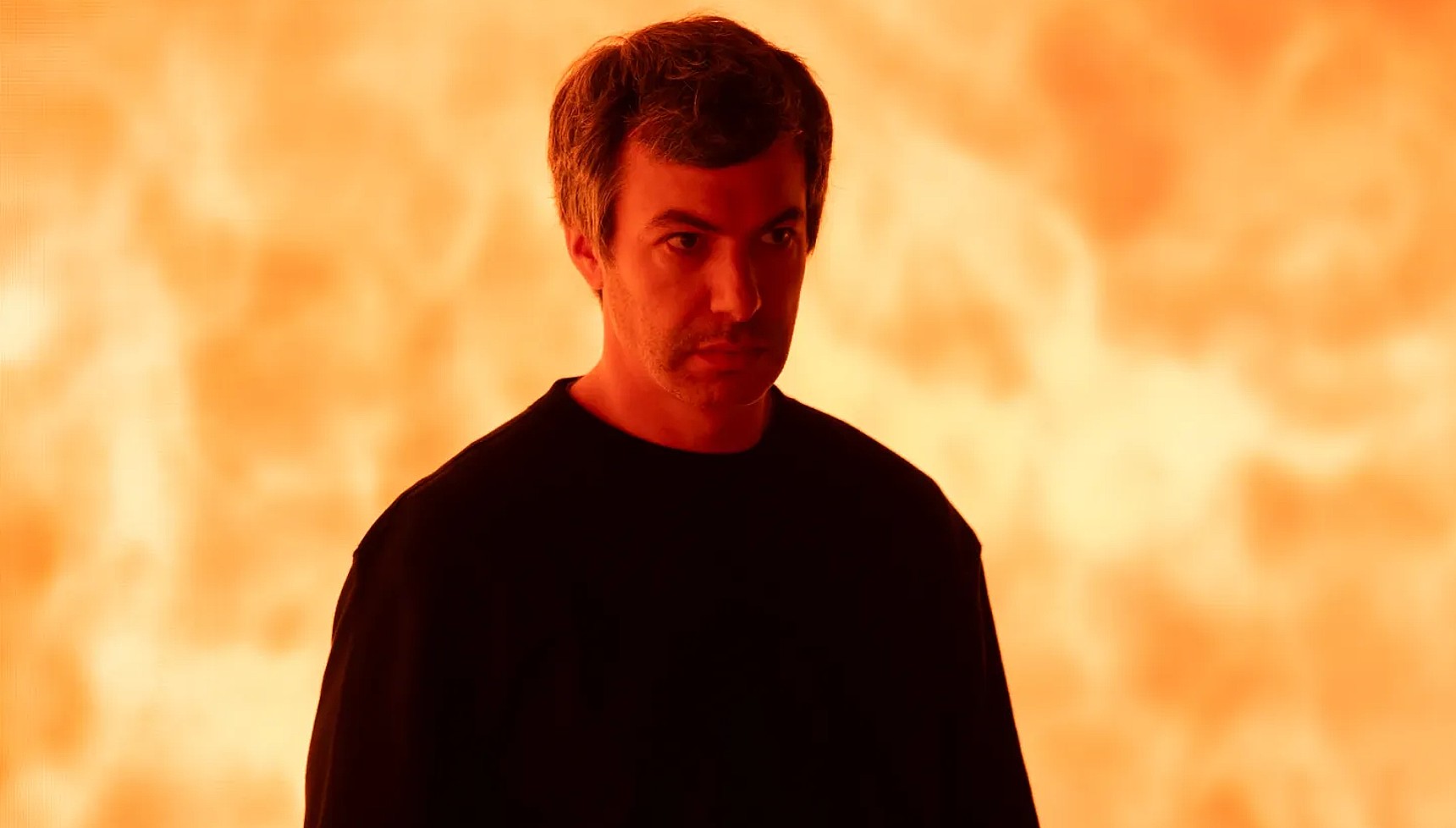 Nathan Fielder standing in front of fire in The Rehearsal 