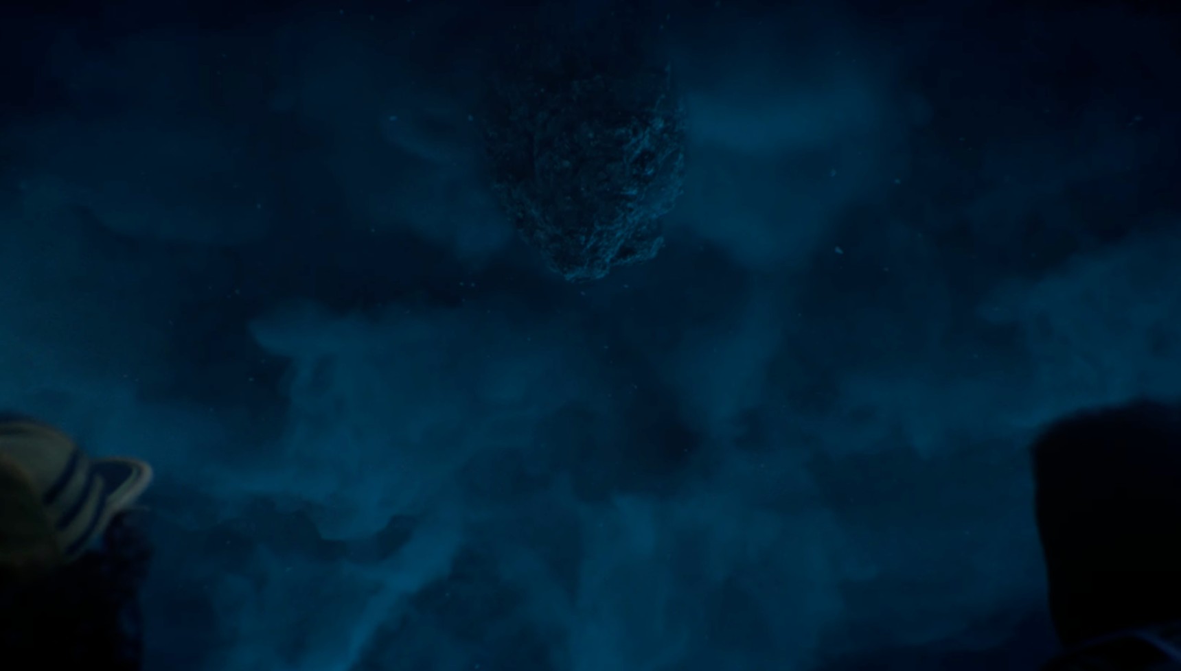 An unknown object poking through the clouds of the Upside Down in the Stranger Things finale