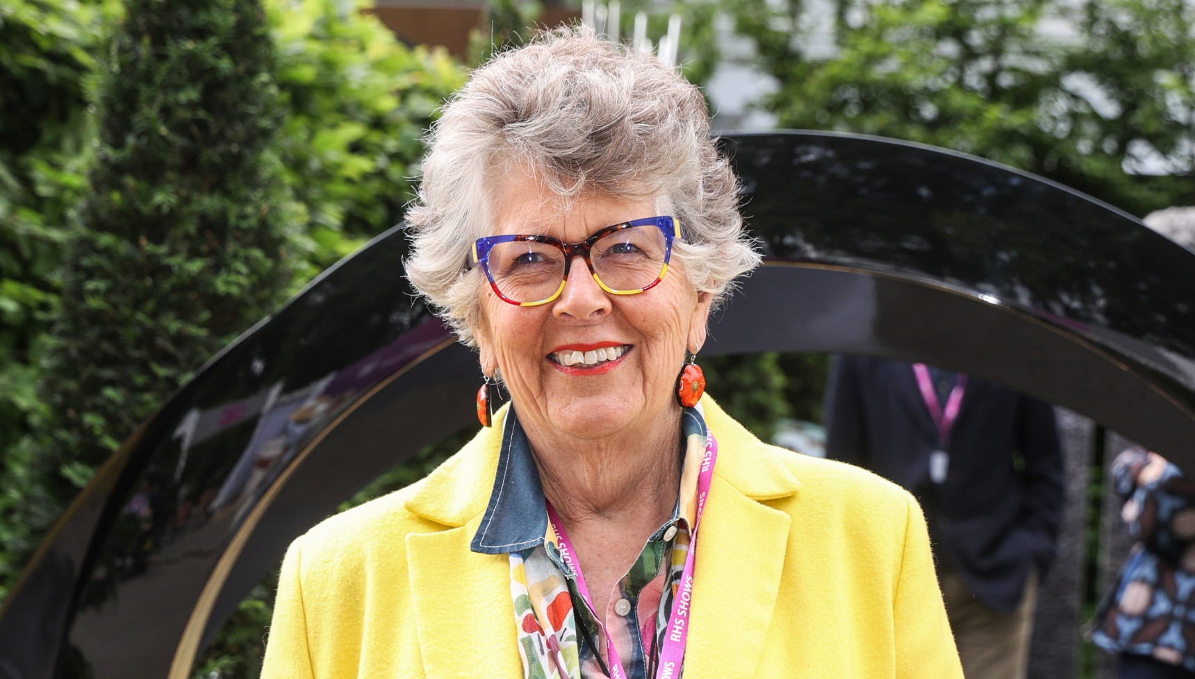Prue Leith smiling wearing yellow