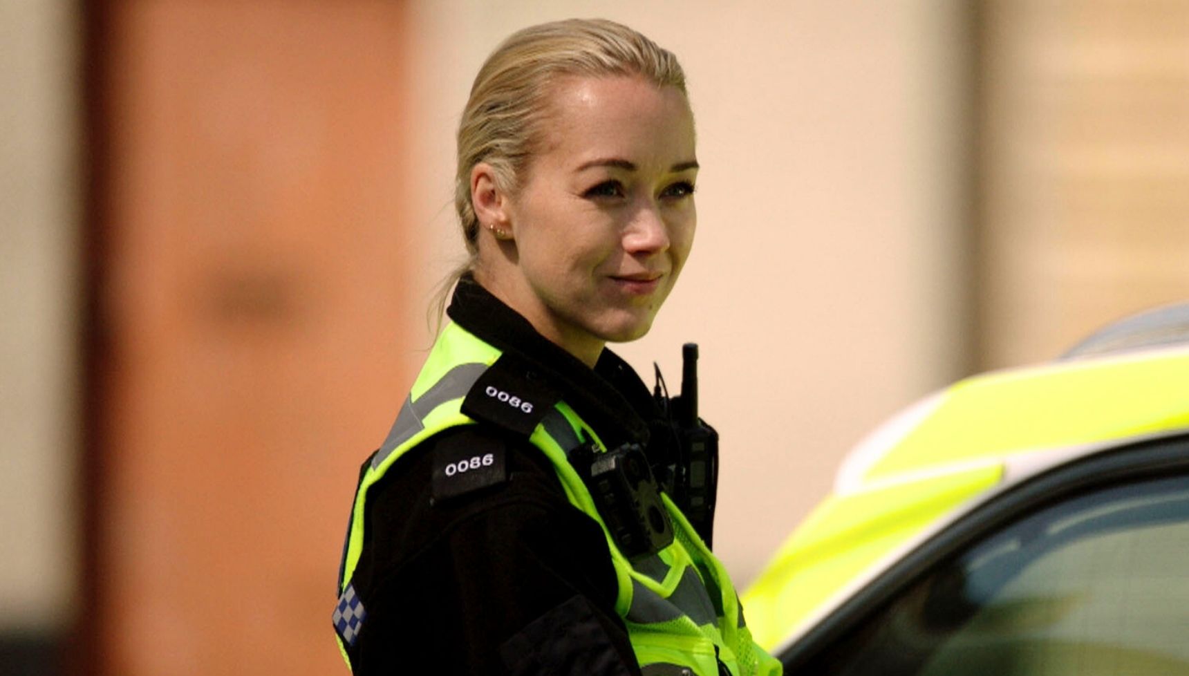 Ashley in a police uniform looking at Teddy, who is off camera in Casualty