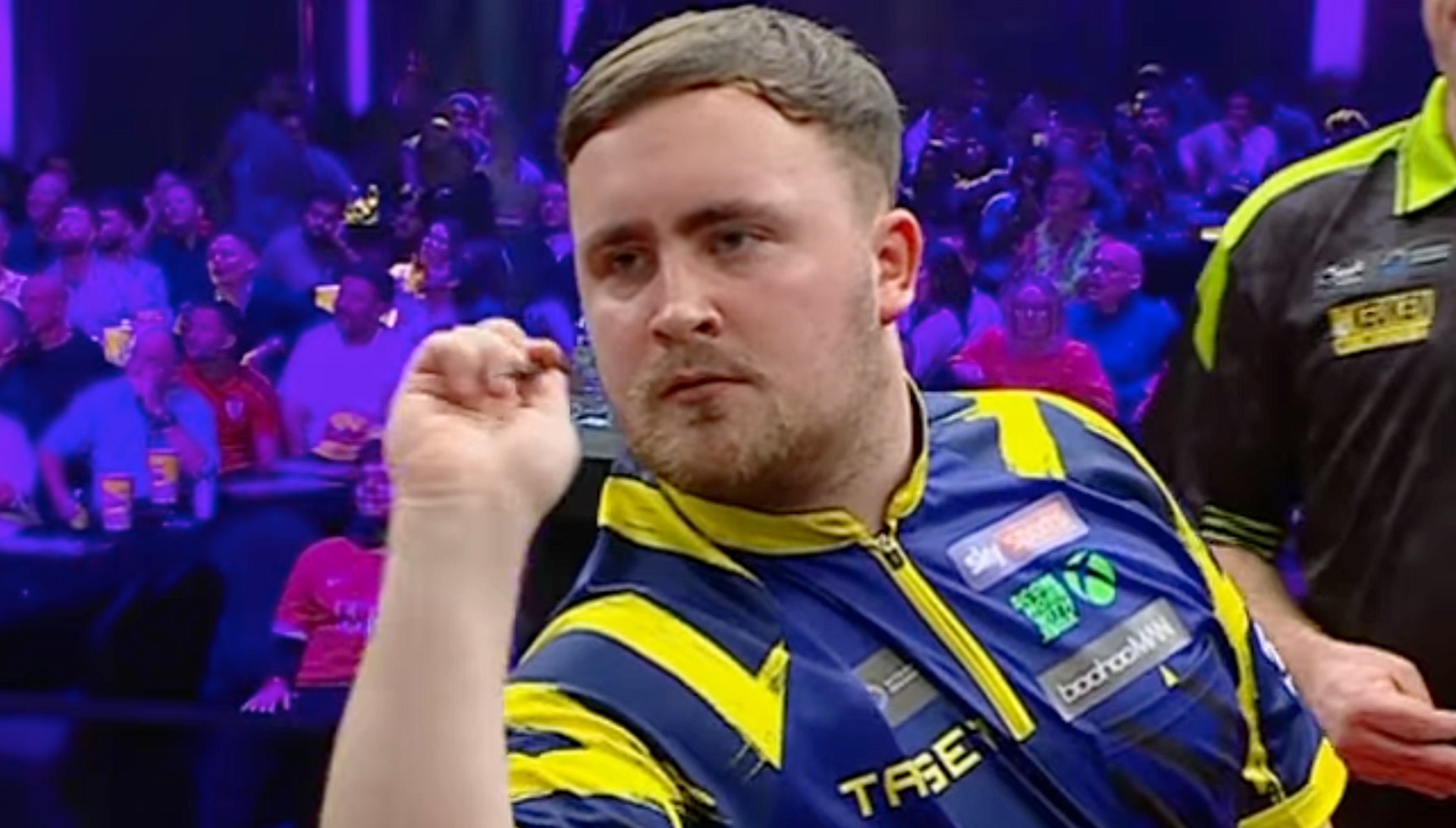 Luke Littler throwing a dart at the Wimmau World Masters