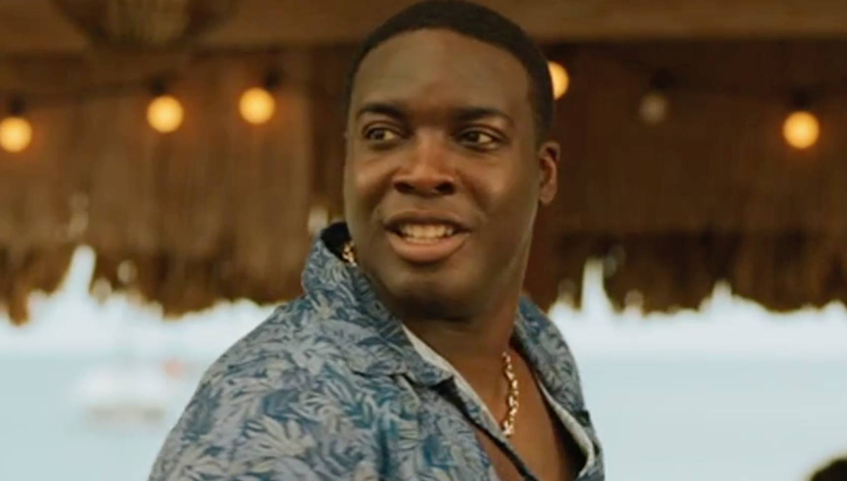 Solomon smiling at Catherine's Bar in Death in Paradise