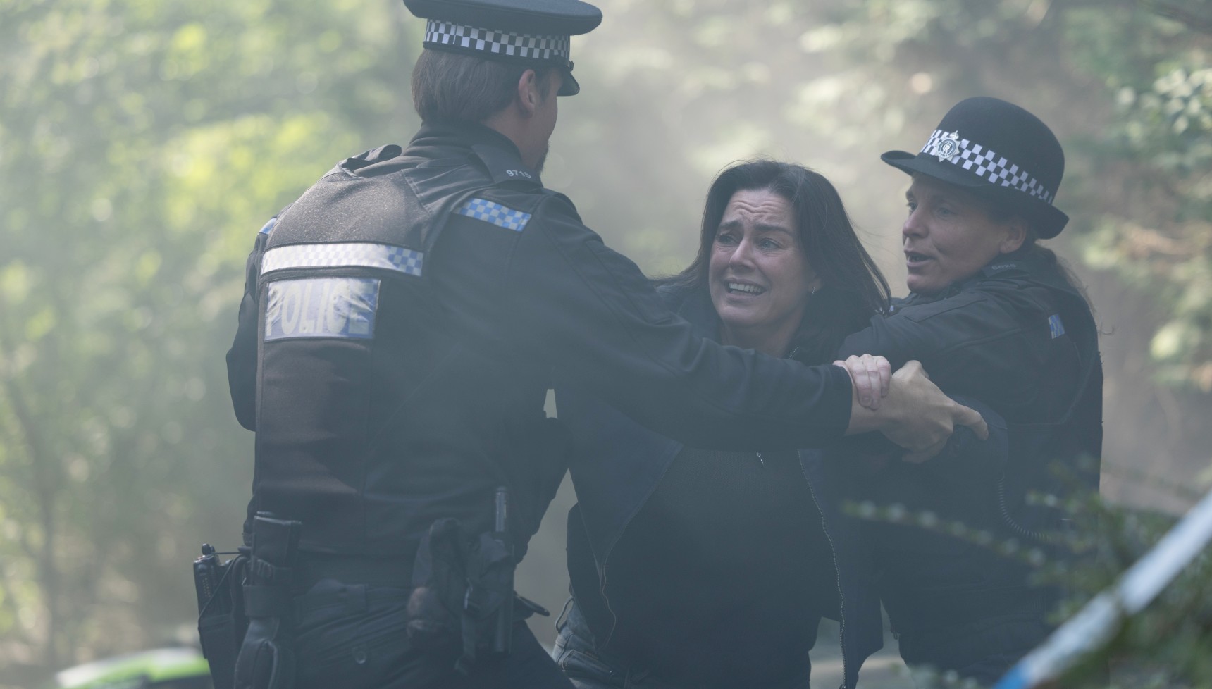 Jill Halfpenny as Eve Riser being held back by police in Girl Taken