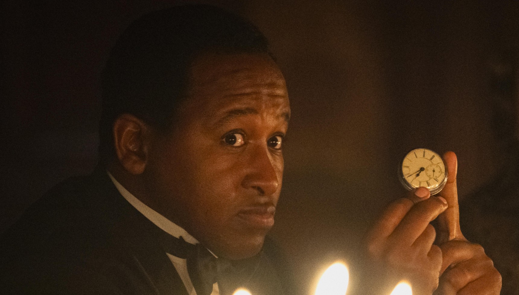 Cyril Matip holding a metal pocket watch in Netflix's Seven Dials