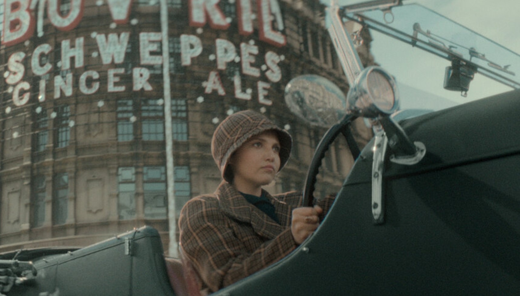 Bundle driving a car in Seven Dials