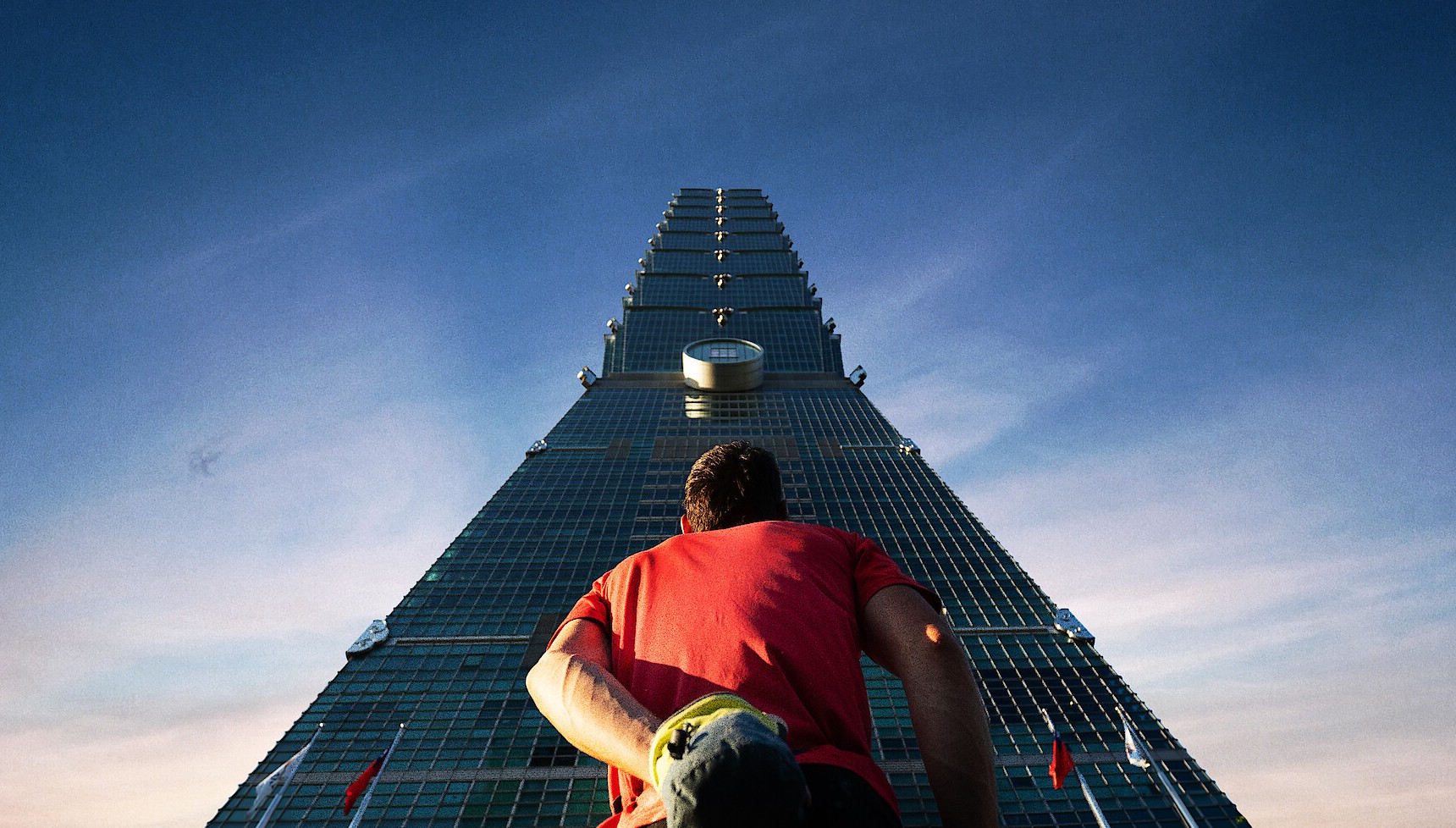 Alex Honnold standing underneath Taipei 101 for Skyscraper Live