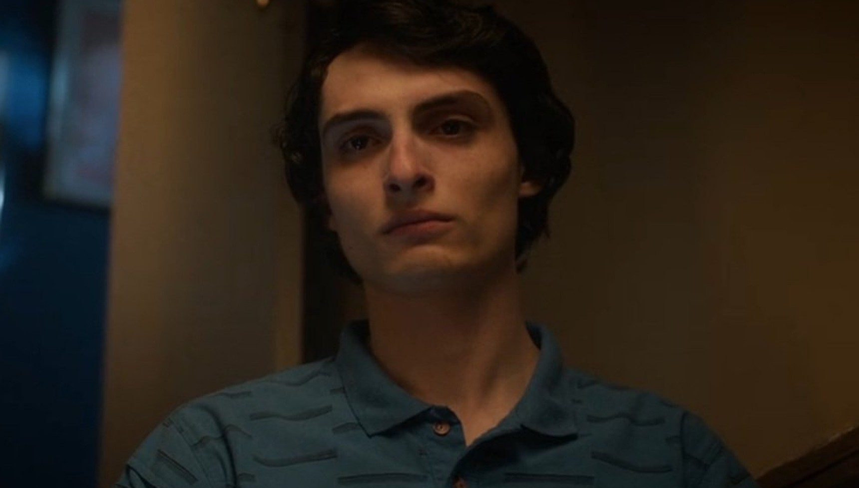 Mike in a blue polo shirt at the end of Stranger Things season 5