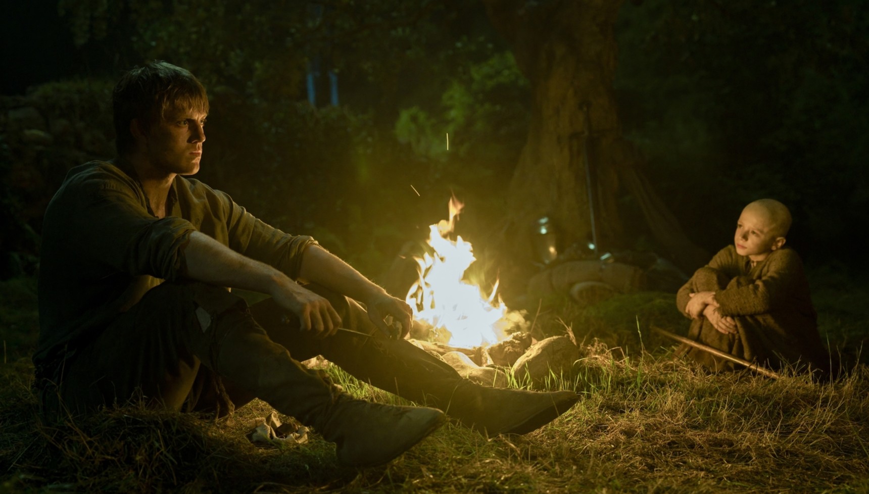 Dunk and Egg sitting by a fire in A Knight of the Seven Kingdoms