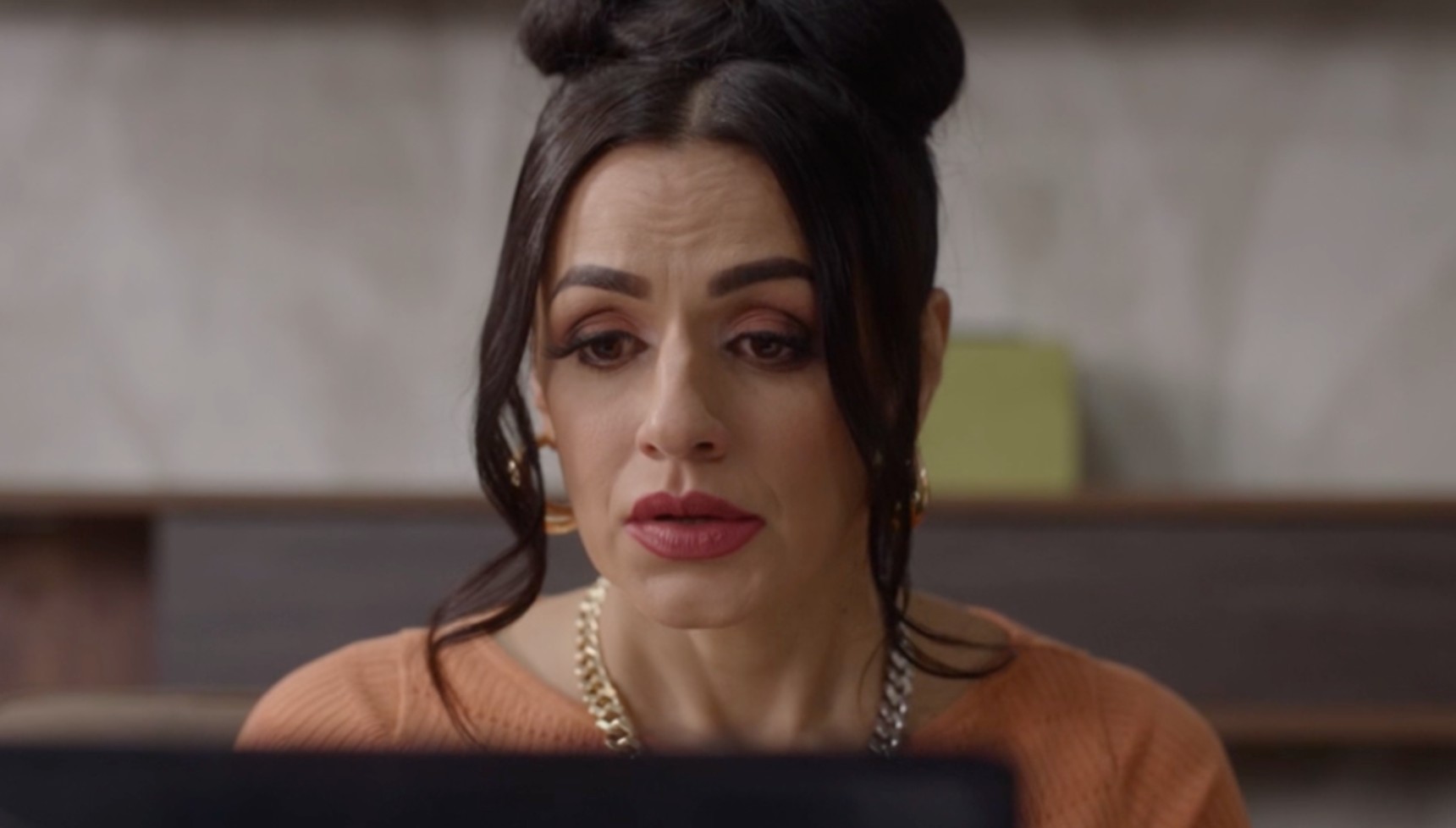 Nisha looking at a computer in Waterloo Road