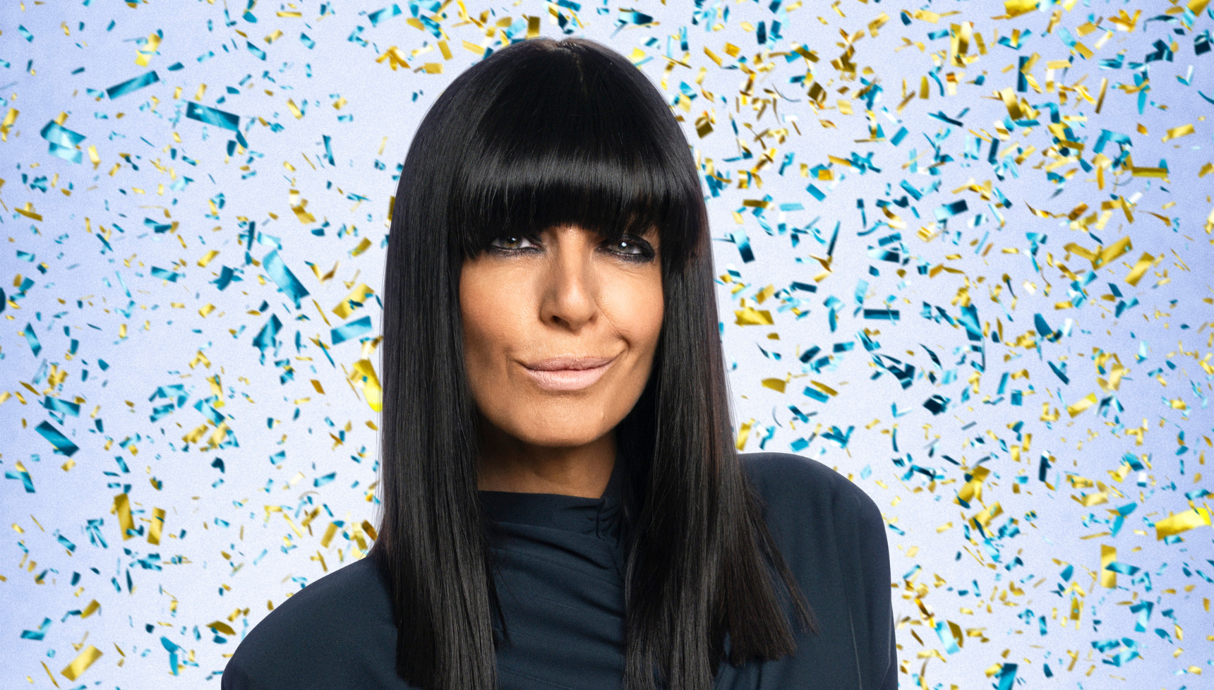 Claudia Winkleman against a blue sparkly background