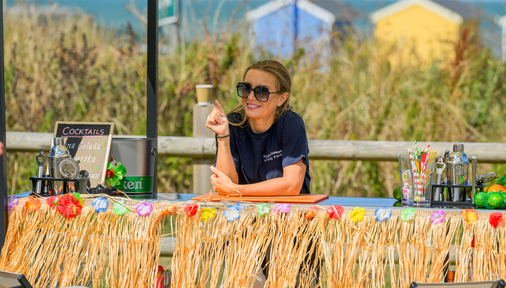 Dani Dyer behind a straw bar at their caravan park