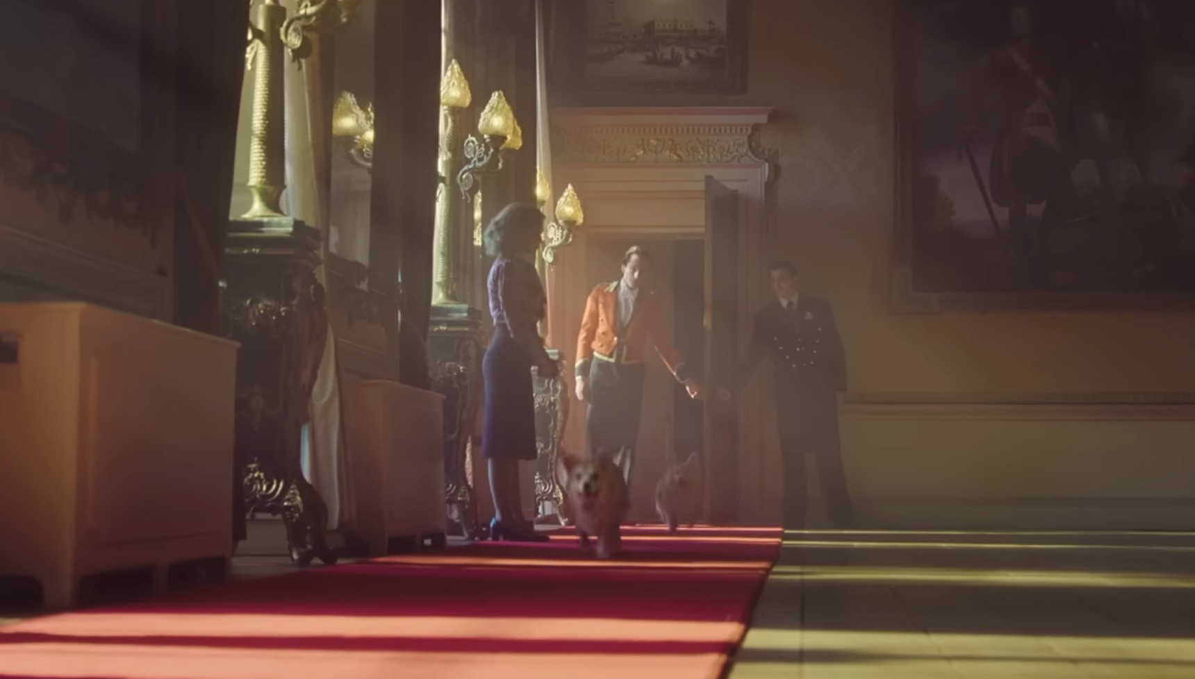 Mia McKenna-Bruce's Jane Andrews standing in a hallway with corgis running in The Lady