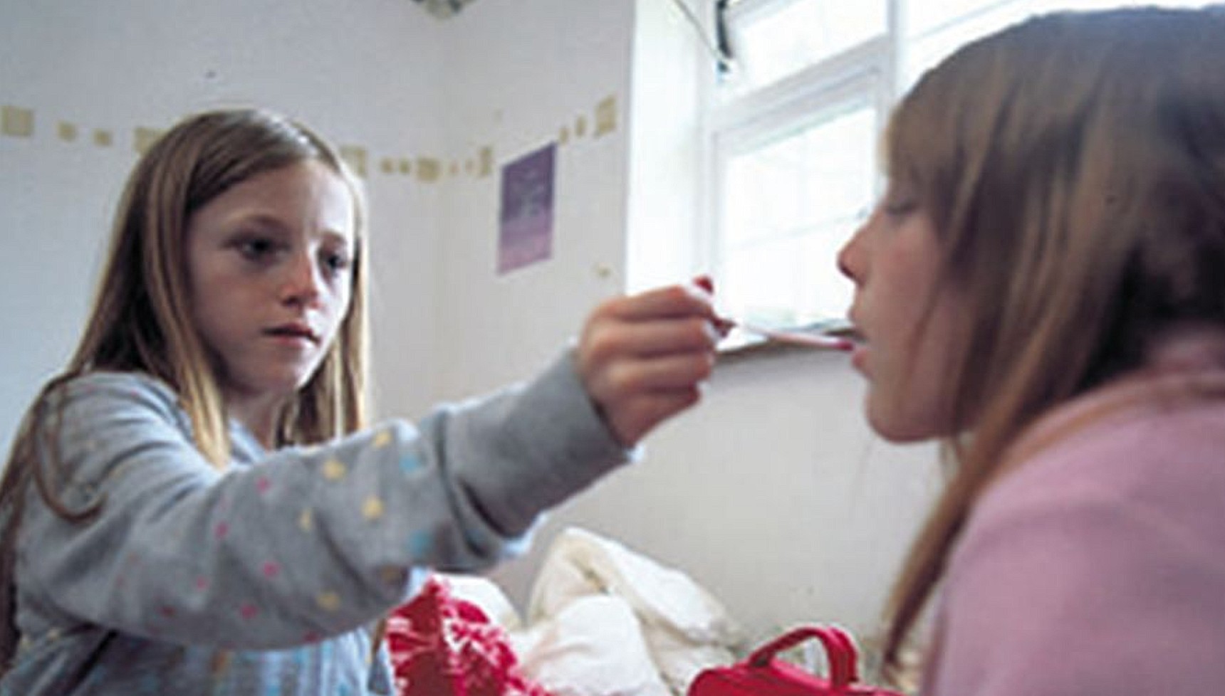 A girl taking another girl's temperature in Boys and Girls Alone