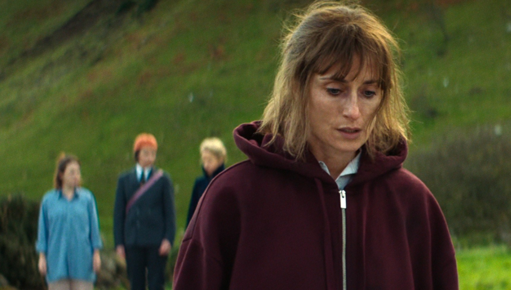 Greta standing in front of Saoirse, Robyn, and Dara in How to Get to Heaven from Belfast