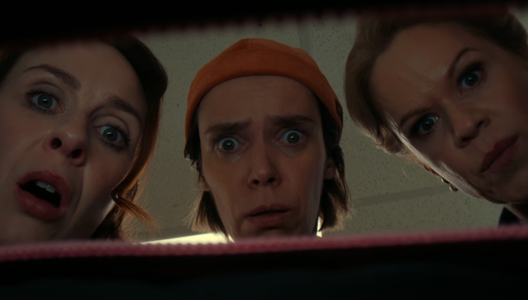 Saoirse, Dara, and Robyn looking into a pink bag