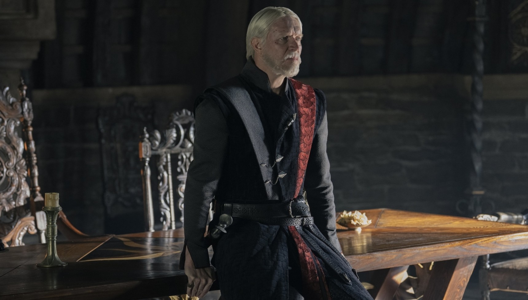 Maekar leaning against a table in A Knight of the Seven Kingdoms 