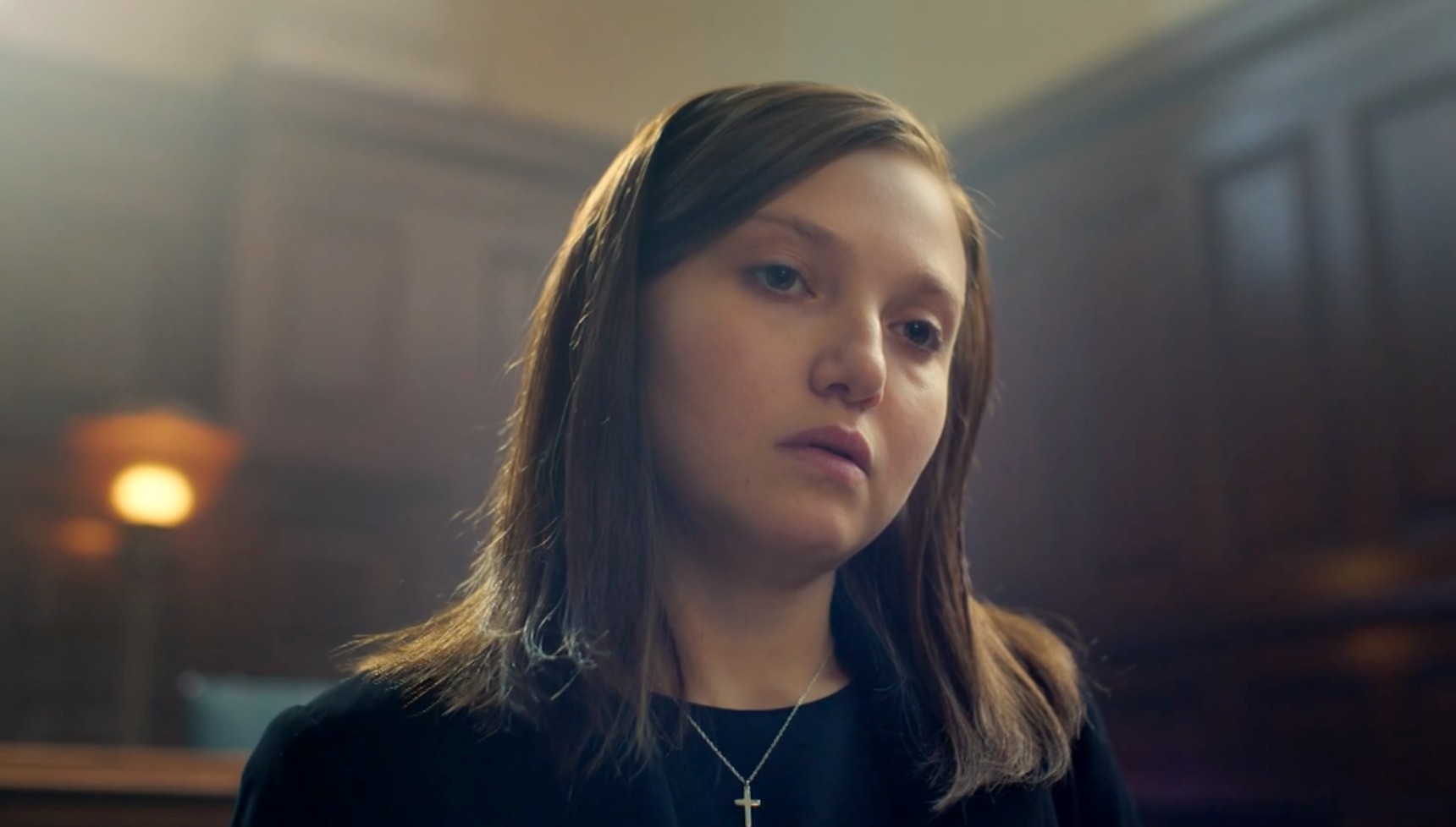 Mia McKenna-Bruce as Jane Andrews standing in court in The Lady