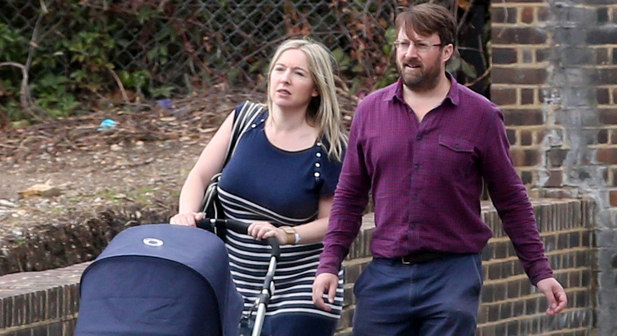 David and Victoria Mitchell pushing a pram