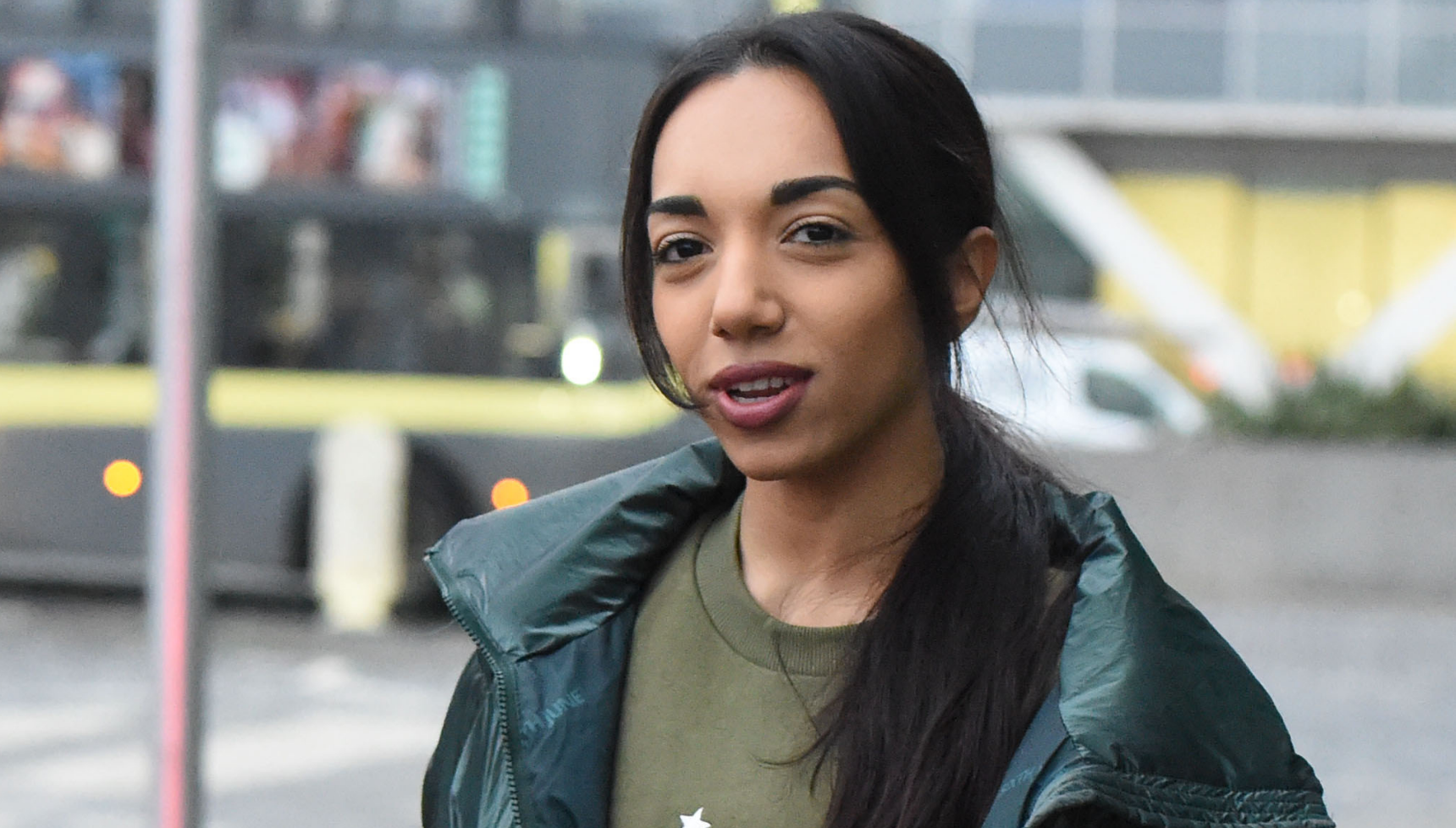 Michelle Tsiakkas in the street in a green coat