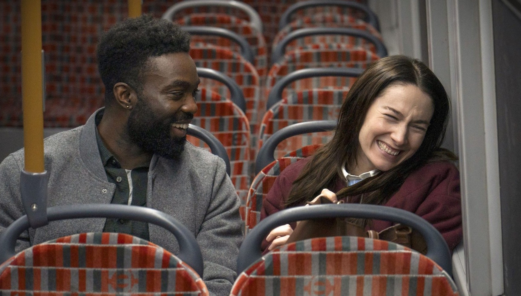 Paapa Essiedu and Siobhan Cullen laughing on the bus in Babies