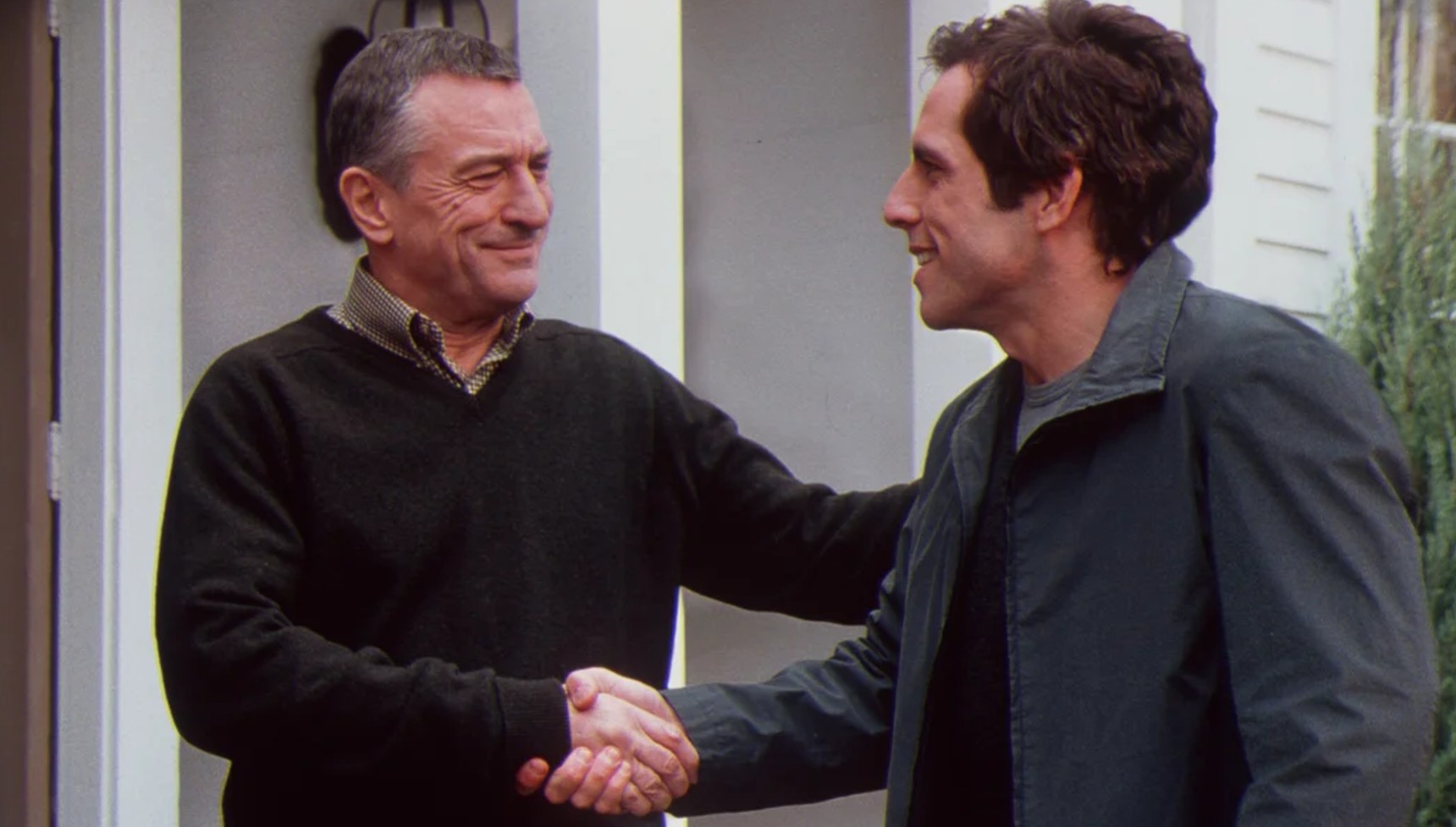 Robert De Niro and Ben Stiller shaking hands in Meet the Parents